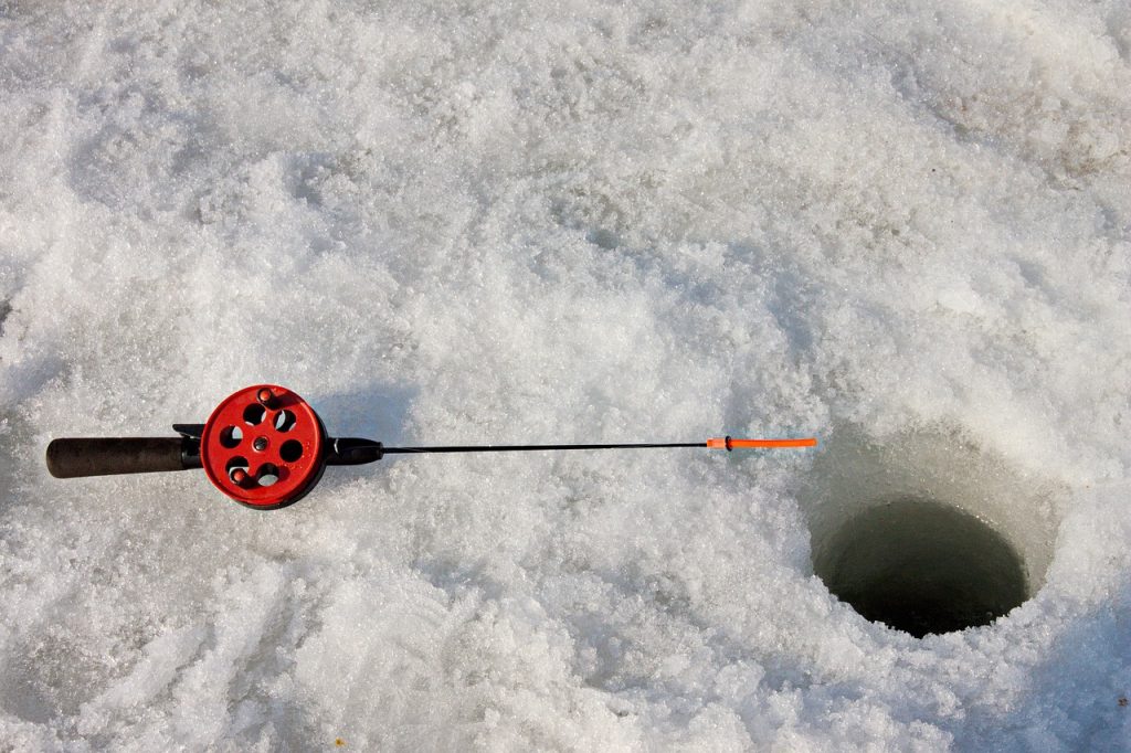pole laying next to ice fishing hole on Leech Lake, MN