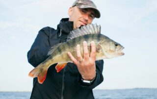 Angler holding walleye at sunrise dock on Leech Lake near Walker MN